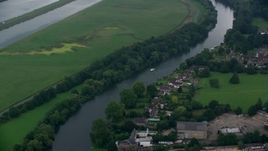 5.5K aerial stock footage of orbiting homes along the River Thames, Windsor, England Aerial Stock Footage | AX114_330