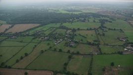 5.5K aerial stock footage of flying over rural homes and farmland, Windsor, England Aerial Stock Footage | AX114_331