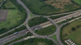 5.5K aerial stock footage of orbiting M25 Freeway roundabout, Chertsey, England Aerial Stock Footage | AX114_354