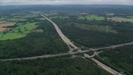 5.5K aerial stock footage following the M25 Freeway past farmland and forests, Cobham, England Aerial Stock Footage | AX114_359E