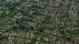 5.5K aerial stock footage tilt from homes to reveal farm fields, Leatherhead, England Aerial Stock Footage | AX114_369E