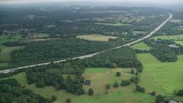 5.5K aerial stock footage of village homes and trees near Walton Heath Golf Club in Tadworth, England Aerial Stock Footage | AX114_374E