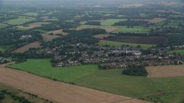 5.5K aerial stock footage of passing by a farmland community, Redhill, England Aerial Stock Footage | AX114_385