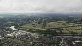 5.5K aerial stock footage approach Hampton Court Palace and Park from residential neighborhoods, England Aerial Stock Footage | AX115_017E