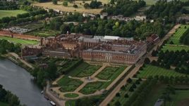 5.5K aerial stock footage of an orbit of Hampton Court Palace by the River Thames, Moseley, England Aerial Stock Footage | AX115_030E