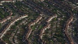 5.5K aerial stock footage of rows of homes in a residential neighborhood, Morden, England Aerial Stock Footage | AX115_042