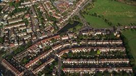 5.5K aerial stock footage of a bird's eye view of suburban neighborhoods and cemetery in London, England Aerial Stock Footage | AX115_046E