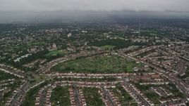 5.5K aerial stock footage fly over suburban homes with rain in the distance, London, England Aerial Stock Footage | AX115_049E