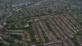 5.5K aerial stock footage of flying over residential neighborhoods in the rain, London, England Aerial Stock Footage | AX115_054E