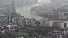 5.5K aerial stock footage of orbiting MI6 Building in the rain, London, England Aerial Stock Footage | AX115_060