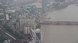 5.5K aerial stock footage of MI6 Building and Vauxhall Bridge over the River Thames in the rain, London, England Aerial Stock Footage | AX115_061E