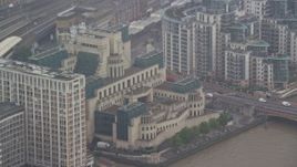 5.5K aerial stock footage of MI6 Building in the rain, London, England Aerial Stock Footage | AX115_063E