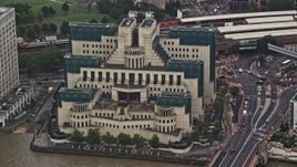 5.5K aerial stock footage of orbiting the MI6 Building in the rain, London, England Aerial Stock Footage | AX115_065E