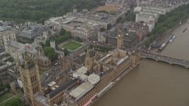 5.5K aerial stock footage fly over Big Ben and Parliament toward Treasury and Foreign Office in the rain, London, England Aerial Stock Footage | AX115_072E