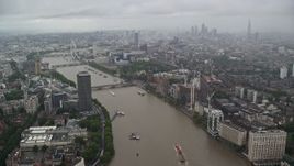 5.5K aerial stock footage of River Thames winding through the city while raining, London, England Aerial Stock Footage | AX115_083E
