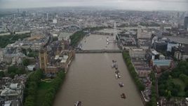 5.5K aerial stock footage of Westminster Bridge while following River Thames past Parliament, London, England Aerial Stock Footage | AX115_087E