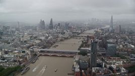 5.5K aerial stock footage of Blackfriars Bridge over River Thames and Central London England Aerial Stock Footage | AX115_090E