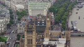 5.5K aerial stock footage of British Flag atop Parliament reveal Big Ben, London England Aerial Stock Footage | AX115_103E