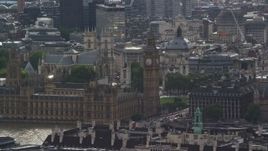 5.5K aerial stock footage of Big Ben and London Eye among city buildings, England Aerial Stock Footage | AX115_111E