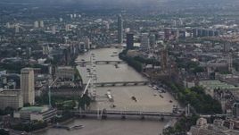 5.5K aerial stock footage of Big Ben and London Eye, and bridges spanning River Thames, England Aerial Stock Footage | AX115_116E