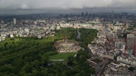 5.5K aerial stock footage of orbiting Buckingham Palace with a cityscape view, London, England Aerial Stock Footage | AX115_129