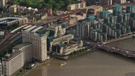 5.5K aerial stock footage of MI6 Building across the River Thames, London, England Aerial Stock Footage | AX115_139E