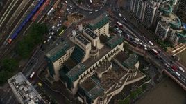 5.5K aerial stock footage of tilting to the MI6 Building in London, England Aerial Stock Footage | AX115_142E