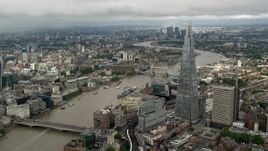 5.5K aerial stock footage of orbiting The Shard overlooking the River Thames, London, England Aerial Stock Footage | AX115_154