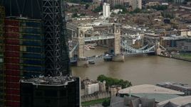 5.5K aerial stock footage flyby skyscraper to reveal Tower Bridge spanning River Thames, Central London, England Aerial Stock Footage | AX115_164