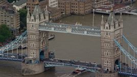 5.5K aerial stock footage of flying beside the Tower Bridge on the River Thames, London, England Aerial Stock Footage | AX115_168E