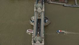 5.5K aerial stock footage tilt to bird's eye of Tower Bridge and passing boats, London, England Aerial Stock Footage | AX115_174