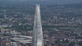 5.5K aerial stock footage of orbiting the top of The Shard, London, England Aerial Stock Footage | AX115_180E