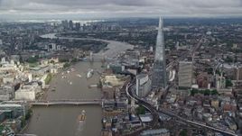 5.5K aerial stock footage pan from The Shard to London Bridge on River Thames, England Aerial Stock Footage | AX115_183E