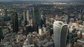5.5K aerial stock footage of approaching The Gherkin and nearby skyscrapers, Central London, England Aerial Stock Footage | AX115_188