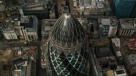 5.5K aerial stock footage tilt to bird's eye view of The Gherkin skyscraper, Central London, England Aerial Stock Footage | AX115_191