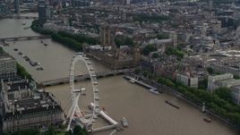 5.5K aerial stock footage of London Eye, Westminster Bridge, Big Ben and Parliament by the Thames, England Aerial Stock Footage | AX115_197