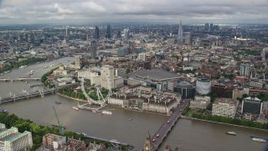 5.5K aerial stock footage of London Eye and River Thames against the cityscape, London, England Aerial Stock Footage | AX115_200