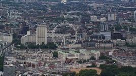 5.5K aerial stock footage of the London Eye and nearby city buildings, England Aerial Stock Footage | AX115_249
