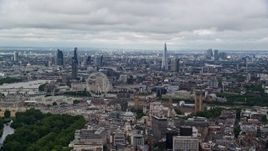 5.5K aerial stock footage of the cityscape, the London Eye, and Parliament, England Aerial Stock Footage | AX115_256E