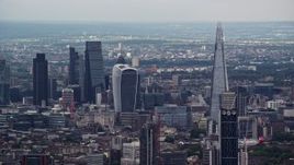 5.5K aerial stock footage of Central London skyscrapers, The Shard and Strata in foreground, England Aerial Stock Footage | AX115_275E