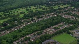 5.5K aerial stock footage of passing residential neighborhoods and trees, Coulsdon, England Aerial Stock Footage | AX115_301E