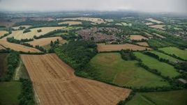 5.5K aerial stock footage fly over farmland and past rural homes in a village, Coulsdon, England Aerial Stock Footage | AX115_303E
