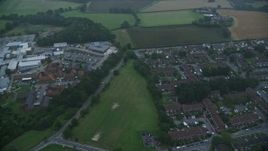 5.5K aerial stock footage of flying by homes, East Surrey Hospital, Redhill, England, twilight Aerial Stock Footage | AX116_001