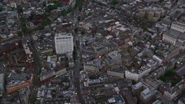 5.5K aerial stock footage of flying over Westminster city streets near office building, London, England, twilight Aerial Stock Footage | AX116_035E