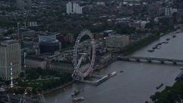 5.5K aerial stock footage of flying by London Eye and Westminster Bridge over River Thames, London, England, twilight Aerial Stock Footage | AX116_057E