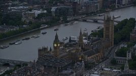 5.5K aerial stock footage of flying by Big Ben and British Parliament on River Thames, London, England, twilight Aerial Stock Footage | AX116_059E
