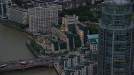 5.5K aerial stock footage of flying by MI6 Building and St George Wharf Tower, London, England, twilight Aerial Stock Footage | AX116_069