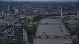 5.5K aerial stock footage of Big Ben, London Eye and bridges spanning the River Thames, London, England, twilight Aerial Stock Footage | AX116_070E