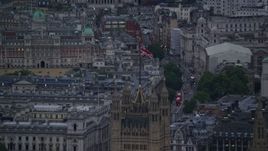 5.5K aerial stock footage of the British Flag atop the British Parliament, London, England, twilight Aerial Stock Footage | AX116_072