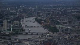 5.5K aerial stock footage of London Eye, bridges over River Thames, Big Ben and British Parliament, London, England, twilight Aerial Stock Footage | AX116_094E